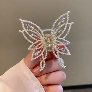 Elegant gold butterfly hair claw with white pearls and sparkling rhinestones for women