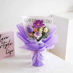 Handmade knitted yarn flower bouquet with sunflowers in purple gift wrapping