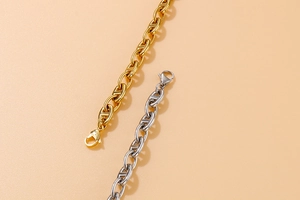 Close-up of gold and silver stainless steel oval link pig nose chains with lobster clasps