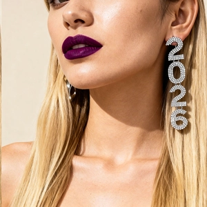 Exaggerated silver fringe earrings with rhinestone numbers 2026 on a model