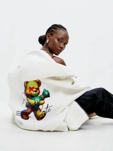 Detail of white hoodie featuring a cute cartoon bear print and stylish back lettering
