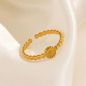 Macro shot of 18k gold plated stainless steel sun flower ring on silk backdrop