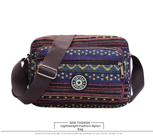 Detail of bohemian striped canvas crossbody bag with adjustable strap and front zipper pocket