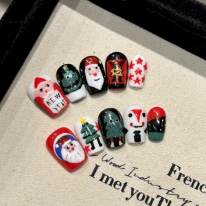 Cute Christmas Santa Claus press-on nails with red and green festive hand-painted designs