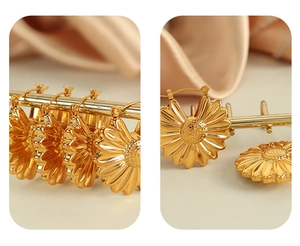 Macro shot of 18K gold plated hollow sunflower petal earrings with detailed 3D floral textures