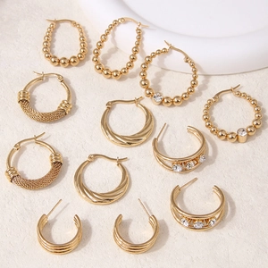 Detailed view of assorted gold stainless steel hoop earrings with textured finish and zircon