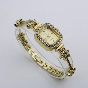 Detailed side view of luxury gold square watch with crystal bezel and floral bracelet