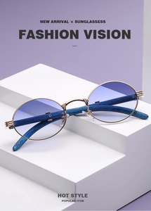 Detail view of oval golden metal frame sunglasses with blue wood grain textured temples