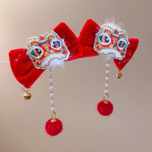 Detail view of red velvet bow hair clips with traditional lion dance embroidery and pearls