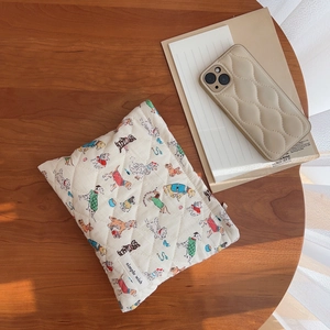 Quilted cartoon dog pattern storage bag on a wooden table with matching accessories