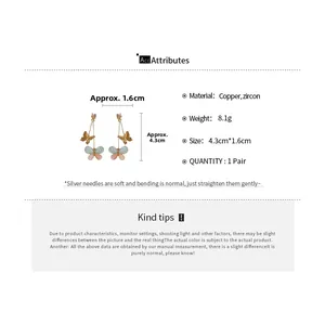 Detail view of double butterfly earrings featuring blue and pink zircon charms, 4.3cm length