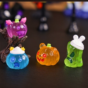 Macro shot of 4 colorful resin Halloween pumpkin figurines on a natural tree stump base