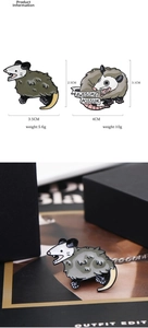 Close-up of awesome possum enamel pins showing detailed green zinc alloy design