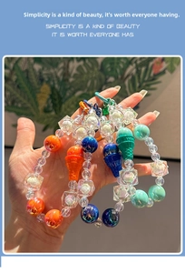 Detail of beaded acrylic keychain with flower cubes and ice cream cone charm