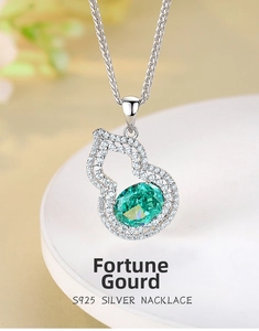 Macro shot of S925 silver gourd pendant with emerald green stone and zircon inlay