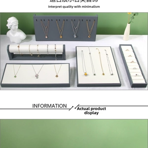 Modern grey velvet jewelry display set featuring necklace stand, ring tray and bracelet holder