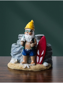 Detail of beach gnome salt and pepper shaker holder with surfboard and glass jars