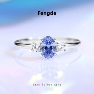 Macro shot of S925 silver ring featuring oval blue gemstone and side stones detail