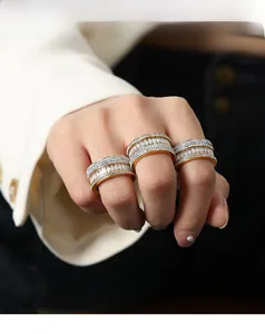 Macro shot of 18k gold plated wide rings featuring tiered zircon and diamond settings
