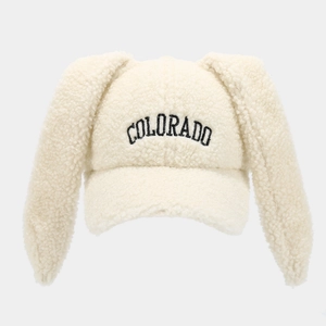 Detailed view of white fluffy teddy fleece baseball cap with cute bunny ears and embroidery