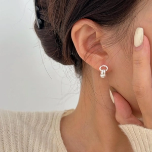 Detail of minimalist 925 sterling silver knotted hoop earrings on female model