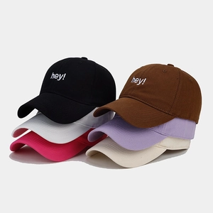 Close-up of 'hey!' embroidery details and multiple color options for the baseball cap