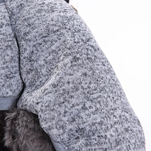 Close-up of gray knitted fabric texture and ribbed cuff for small dog winter sweater
