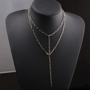 Detail of Y-shaped paperclip chain necklaces in gold and silver finish on a neck model