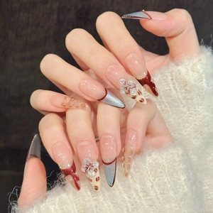 Blue Blood carving press-on nails with 3D flower patterns and red French tips on almond shape