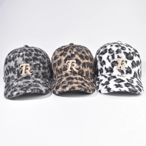 Three leopard print fuzzy baseball hats with metal TR logo in brown, grey and white