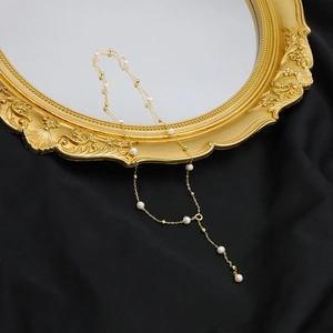 Elegant 18k gold plated long Y-necklace featuring natural freshwater pearls on a fine chain