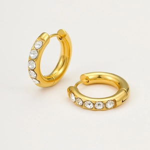 Detail of 18K gold stainless steel huggie earrings featuring inlaid cubic zirconia accents
