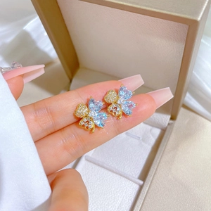 Titanium steel four-leaf clover stud earrings with blue zircon heart stones and gold finish