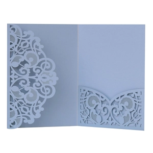 Macro view of laser-cut lace floral pattern on light blue business invitation card