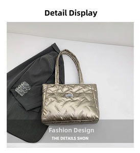 Detail of champagne gold quilted tote bag with FASHION label and sleek metallic finish