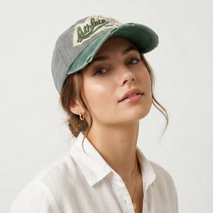 Retro washed baseball cap with contrast patch embroidery and distressed details worn by model