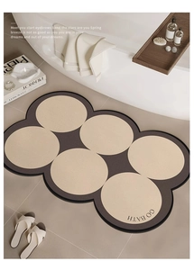 Detail of coffee and beige wavy diatomaceous earth bath mat with GO BATH typography