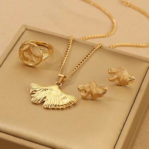 Detailed view of golden ginkgo leaf jewelry set including necklace, ring, and earrings