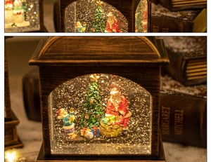 Close-up of vintage bronze Christmas lantern with Santa figurines and swirling glitter snow