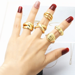 Set of 5 minimalist gold rings with twisted, crossover, and textured band designs