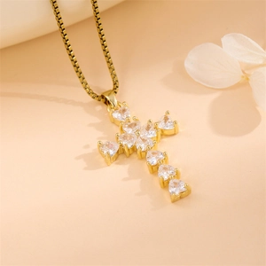 Elegant gold cross necklace with heart-shaped cubic zirconia on a minimalist chain