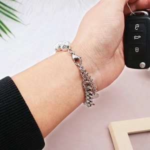 Close-up of double-layer stainless steel bracelet with textured beads on woman's wrist