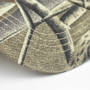 Macro view of jungle camo baseball cap brim with durable reinforced four-row stitching