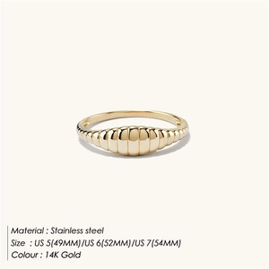 Macro detail of gold croissant style ring showing stainless steel texture and 14K finish
