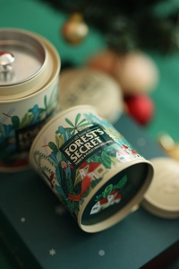 Close-up of forest fox illustration on mini tinplate tea canister with inner lid