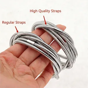 Handheld view of layered silver stackable spring bracelets with spiral texture