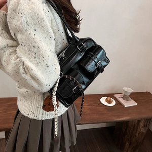 Large black leather shoulder bag with bear charm and double buckle pockets for women
