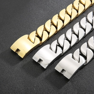 Close-up of thick Cuban link chains in gold, polished silver and matte silver finishes
