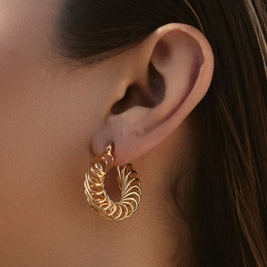 Textured irregular spiral gold-plated metal hoop earrings with a vintage high-end finish