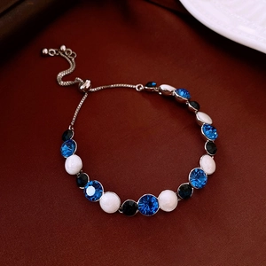 Macro detail of adjustable bolo bracelet with blue crystals and vintage black beads